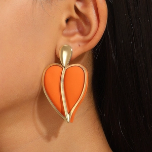 Fashionable oversized orange heart earrings with gold metal frame and teardrop hook