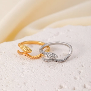 Macro shot of gold and silver snake rings with sparkling micro-pave zirconia details