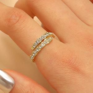 Macro shot of gold-plated snake ring with micro-pave cubic zirconia on female finger