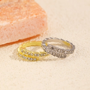 Detail of snake-bone textured ring with micro-pave cubic zirconia on neutral mineral base