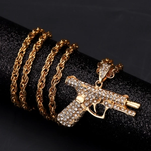 Hip hop gold pistol pendant necklace with sparkling white zircons on chunky rope chain