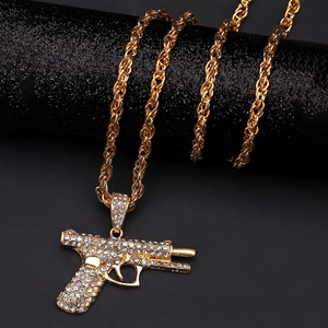 Macro detail of iced-out AK handgun pendant with micro pave crystals on rope chain
