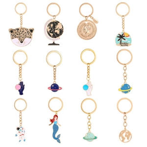 Set of twelve colorful enamel metal keychains in various creative novelty designs