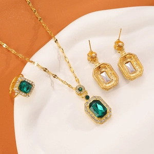 Vintage emerald-style jewelry set with gold necklace, square ring and earrings with diamonds