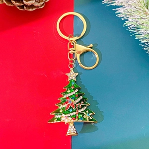 Macro detail of Christmas tree keychain with colorful crystals and gold lobster clasp