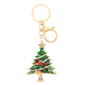 Golden Christmas tree keychain with green enamel and sparkling rhinestones on white background