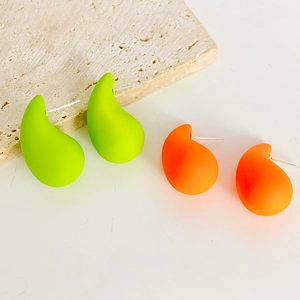 Detail of matte waterdrop earrings in neon green and bright orange with silver studs