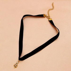 Macro view of velvet Christmas tree choker with gold lobster clasp and adjustable chain