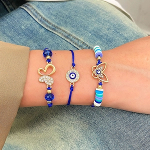 Three-piece set of adjustable woven blue evil eye bracelets with golden butterfly charms