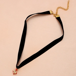 Detail of black velvet choker with gold chain and red Christmas gift box pendant