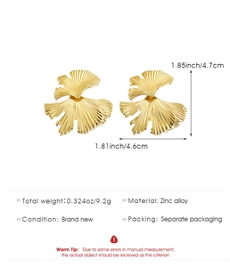 Macro detail of gold ginkgo leaf earrings showing intricate bionic vein textures
