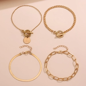 Détail d'un ensemble de 4 bracelets dorés avec chaînes serpent, cubaines et trombones
