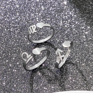 Detailed view of silver zodiac rings with heart accents on star background