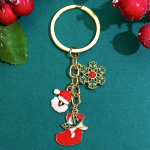 Christmas keychain with Santa Claus, snowflake and red sock pendants on green background