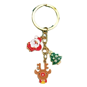 Christmas keychain with Santa Claus, green tree and reindeer pendants on gold ring