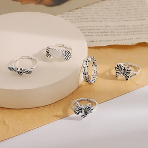 Detailed view of 5-piece vintage silver ring set with heart, butterfly and skull motifs