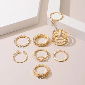 Detail shot of a 7-piece gold ring set featuring zircon accents and geometric designs