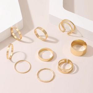 Detail view of 9-piece gold knuckle ring set with various smooth and layered minimalist bands