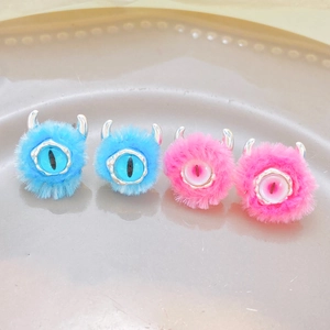 Cute monster plush rings in blue and pink featuring googly eyes and small horns