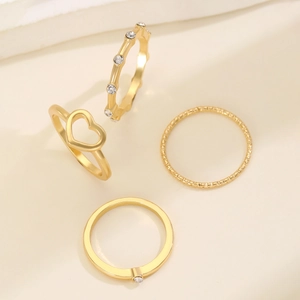 Golden four-piece minimalist ring set with hollow heart and sparkling rhinestones