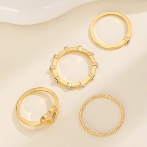 Set of 4 gold rings with hollow heart design and sparkling zircon stones for women