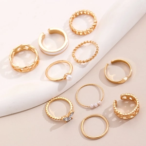Detailed shot of 10-piece gold ring set featuring pearls, butterflies and rhinestones
