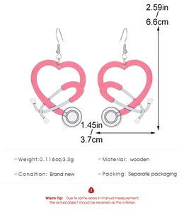 Detail view of pink heart stethoscope wooden earrings with measurements and 3.3g weight