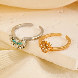 Detailed shot of celestial sun and moon rings with rhinestones on a textured stone