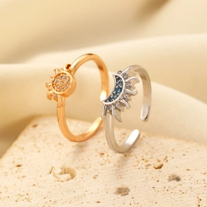 Minimalist sun and moon adjustable ring set with sparkling zircons on stone background