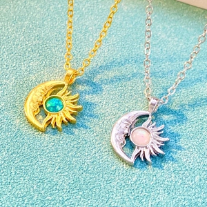 Detail shot of sun and moon rings with opal stones and intricate face relief design