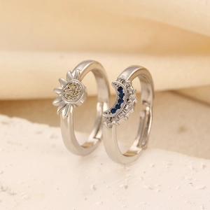 Detailed close-up of sun and moon rings with blue and yellow zircon inlay