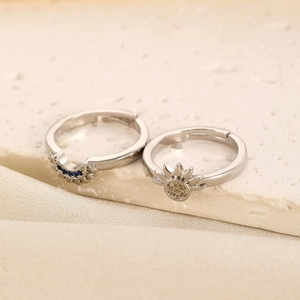 Close-up of vintage sun and moon rings set with crystals on elegant fabric