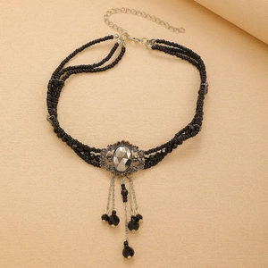Detailed macro view of black beaded choker necklace with gothic gemstone pendant