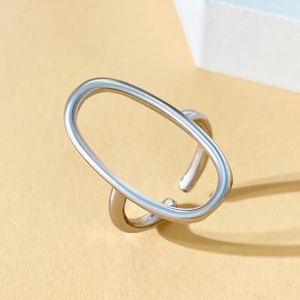 Detailed macro view of silver geometric oval hollow ring with adjustable open band design