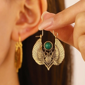 Vintage Egyptian gold winged scarab earrings with green stone and tribal design