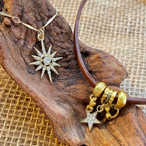 Brown leather choker and star pendant necklace set displayed on rustic linen and wood