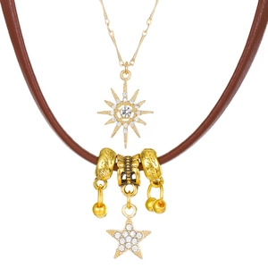 Close-up of double-layer necklace with gold star charms and brown leather cord