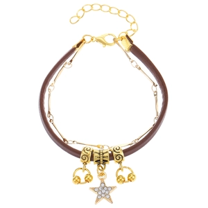 Close-up of layered necklace with brown leather cord, gold chain and sparkling star pendant