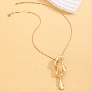 Close-up of golden liquid lava pendant on a snake chain with lobster clasp detail