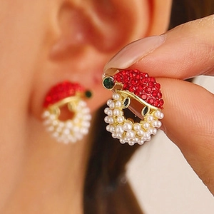 Detailed view of Christmas hat earring with red rhinestones and white pearls