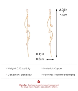 Detailed view of long gold tassel flower earrings with cubic zirconia and dimension info