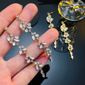 Detailed view of long crystal tassel earrings with floral marquise-cut rhinestones