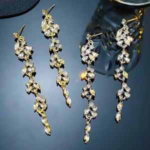 Luxurious gold floral tassel drop earrings with sparkling rhinestones and vine leaf design