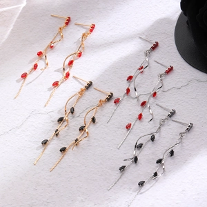 Detail view of long tassel earrings with marquise rhinestones in four color combinations