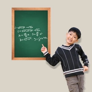 Kids black knit sweater with white stripes and monkey logo by a green chalkboard