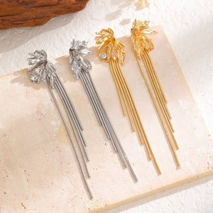Detail view of elegant flower rhinestone tassel earrings in gold and silver finish
