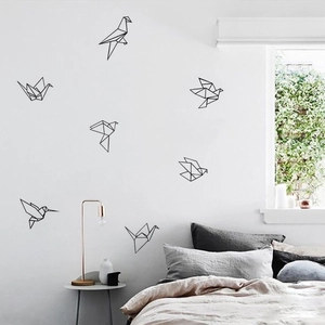 Modern black geometric bird wall decals showing 7 minimalist origami cranes in a bedroom