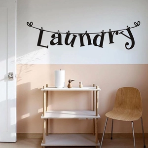 Laundry room wall sticker with clothespin design and hearts on a modern neutral wall