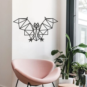 Close-up of a black geometric bat wall sticker on a modern minimalist white wall