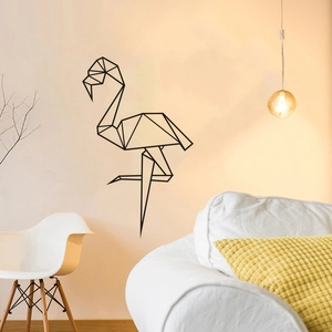 Modern black geometric flamingo wall sticker in a cozy living room with white chair